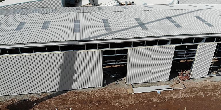 Steel framed building with near complete cladding
